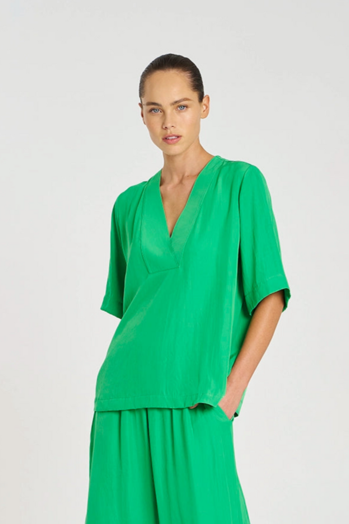 Woman wearing a green outfit on a white background