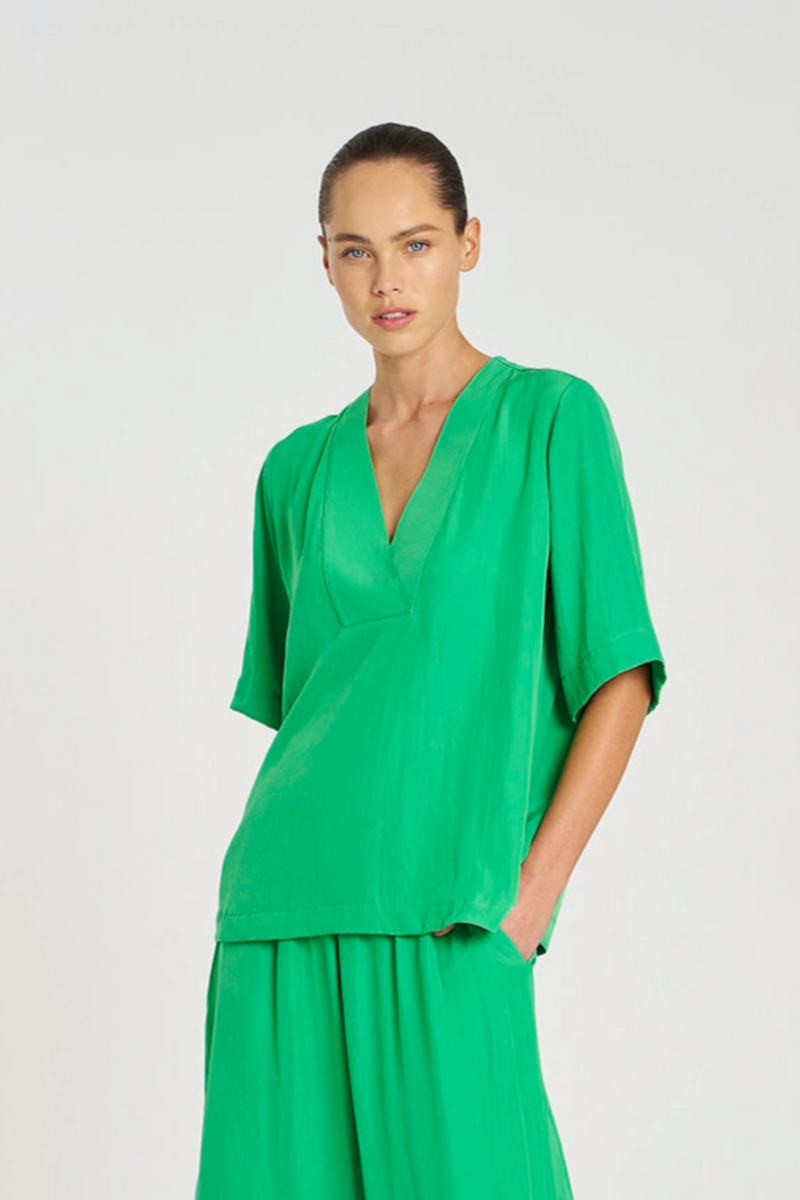 Woman wearing a green outfit on a white background