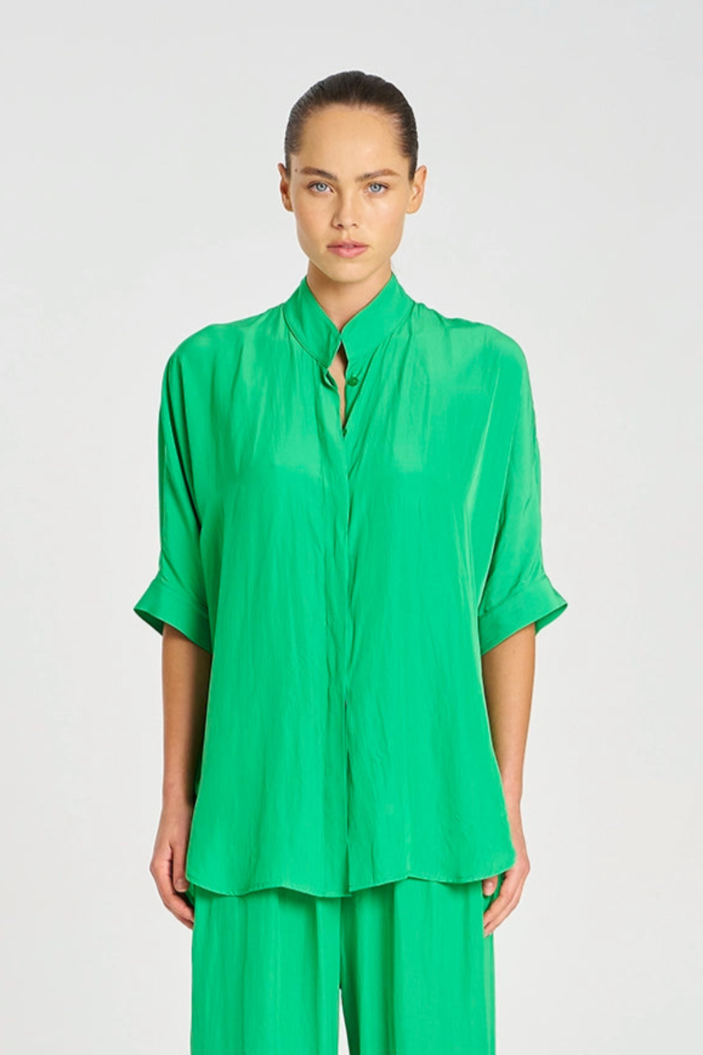 Person wearing a green outfit on a white background