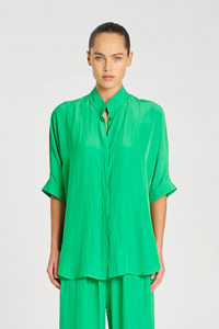 Person wearing a green outfit on a white background