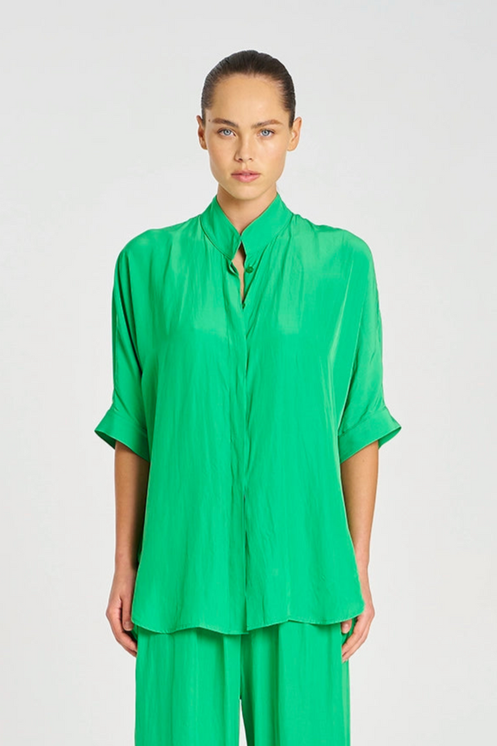 Person wearing a green outfit on a white background