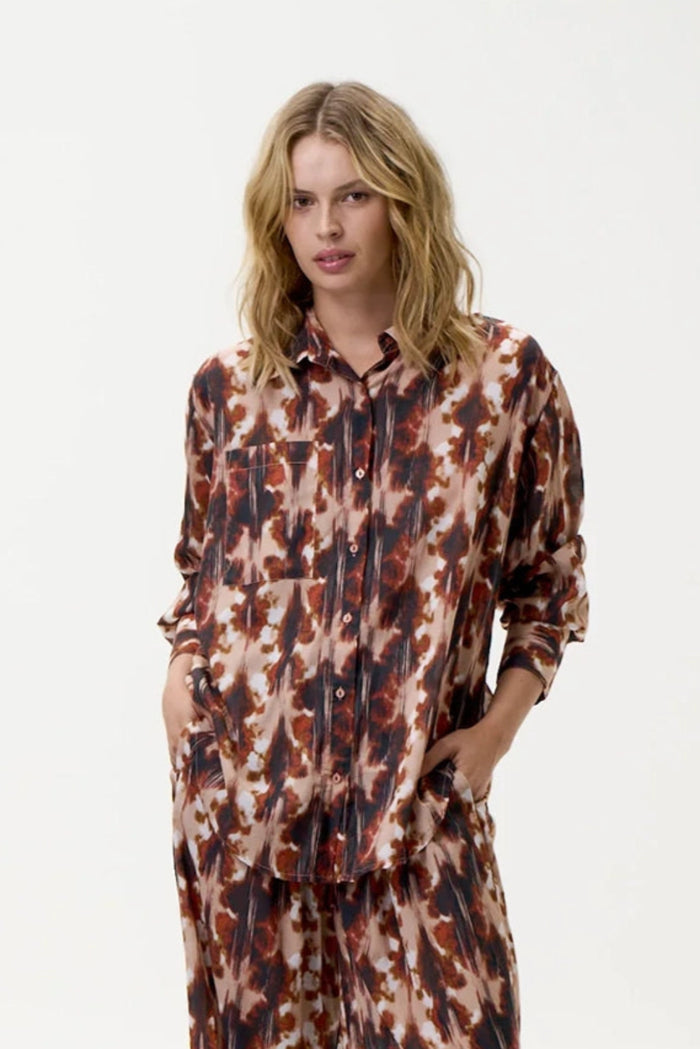Person wearing a patterned outfit on a white background